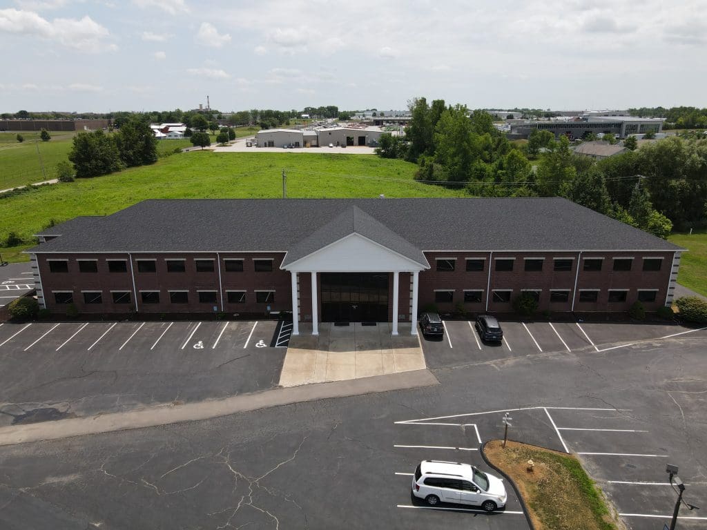 St. Louis two-story brick office building with white columns—ideal for roofing, siding, and gutter service estimates.